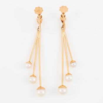 A pair of earrings in 18K gold with cultured pearls.