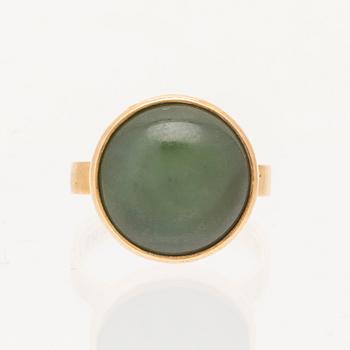 Ateljé Stigbert, an 18K gold ring set with a cabochon cut green stone probably nephrite, 1975.