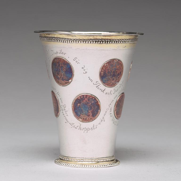 A Swedish 18th century parcel-gilt silver beaker with copper coins, mark of CM Ekman, Eksjö (1729-1738).