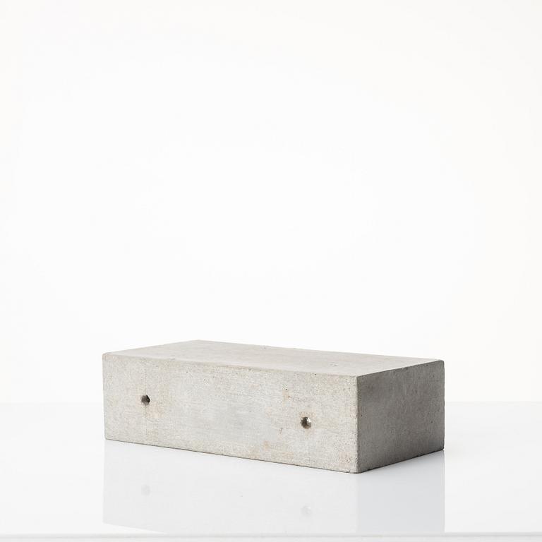 Stina Lindholm, a contemporary concrete planter 'Spira', a concrete flower pot and a wall clock.