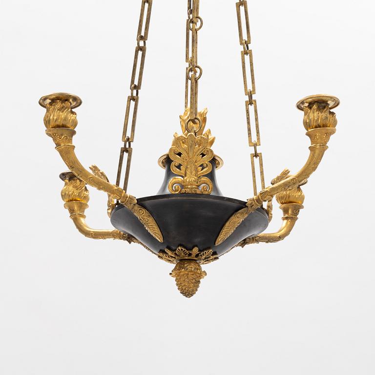 A French Empire ormolu and patinated bronze four-branch chandelier, early 19th century.