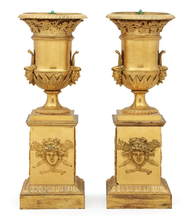 A pair of French Empire early 19th century gilt bronze urns.
