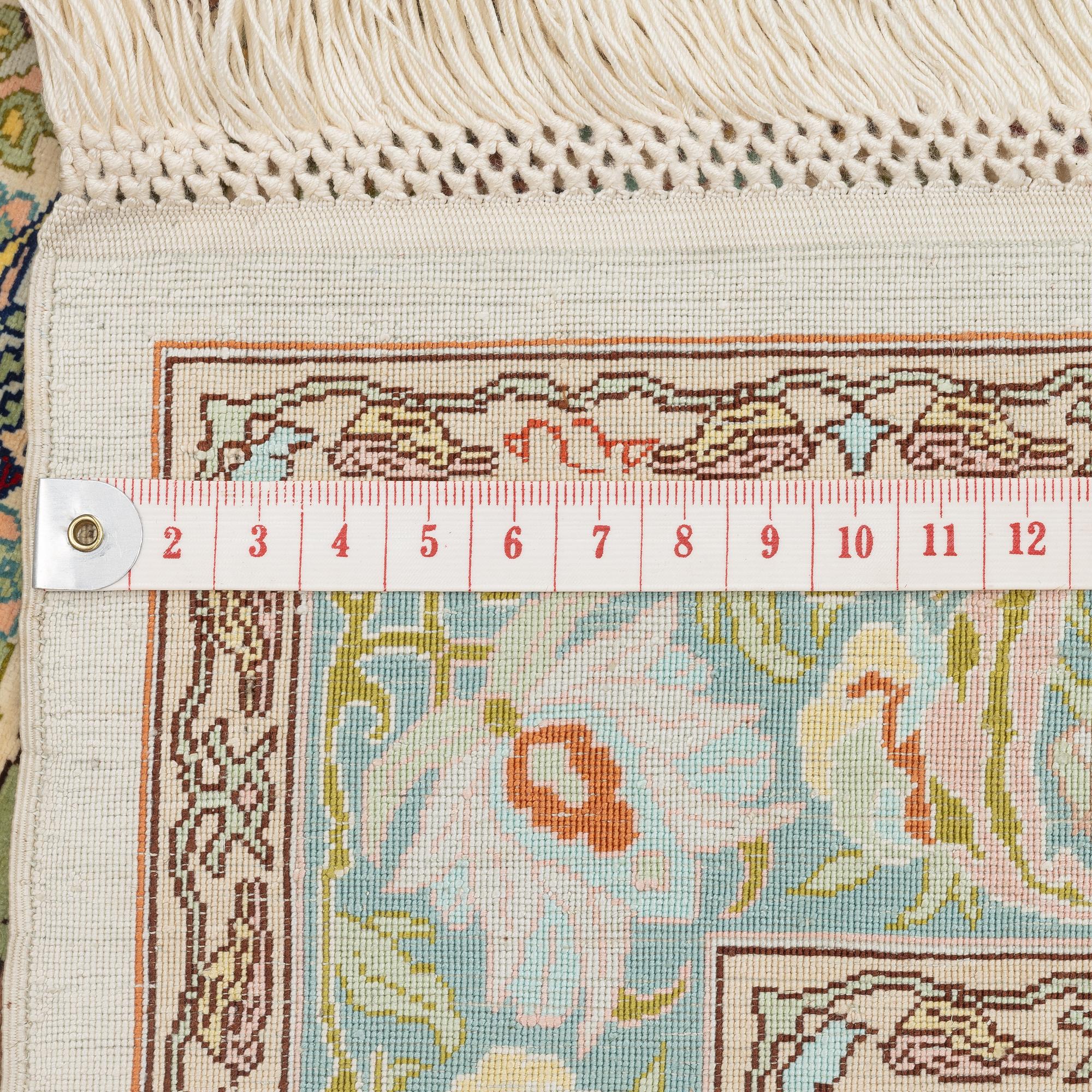 A figural silk Hereke rug, c 65 x 47 cm.