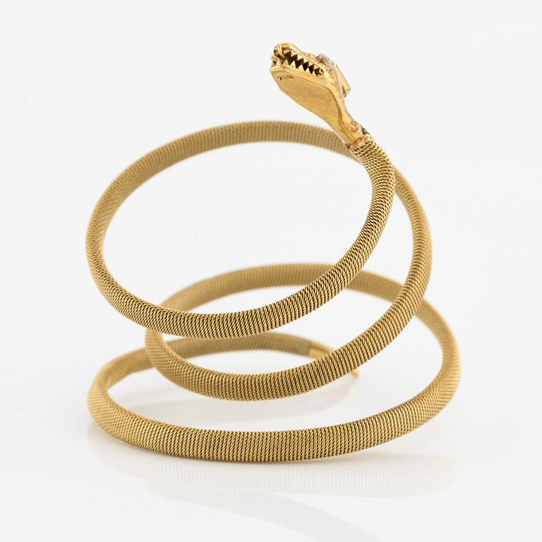 An 18K gold snake bracelet with an emerald and eight-cut diamonds.