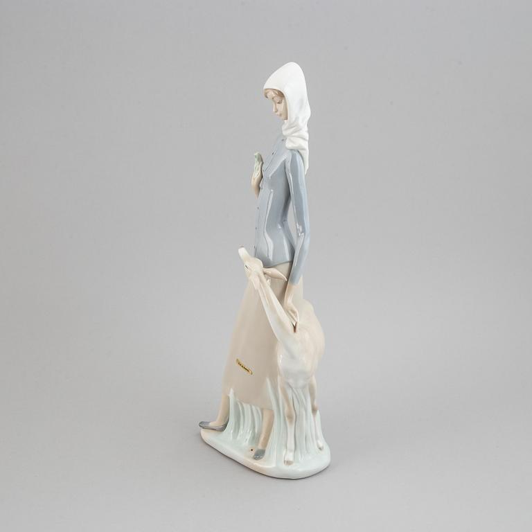 A Lladro porcelain figure of a lady with a dog, Spain, 20th Century.