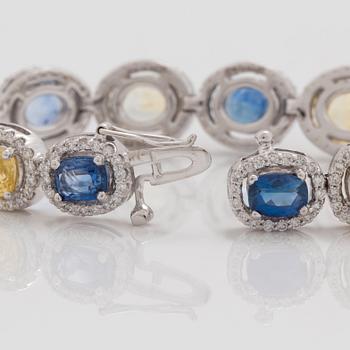 A yellow and blue sapphire and brilliant cut diamond bracelet. Total carat weight of sapphires circa 28.00 cts.