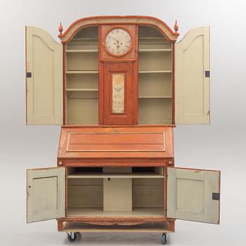 An end of the 18th century cabinet with clock.