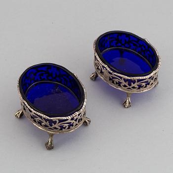 A pair of English 18th century silver and blue glass salt-cellars, unidentified makers mark, London 1767.