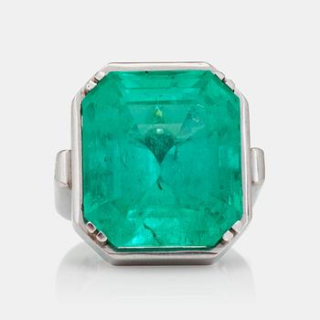 1250. A 26.60ct emerald-cut Colombian emerald and radiant- and step-cut diamond ring.