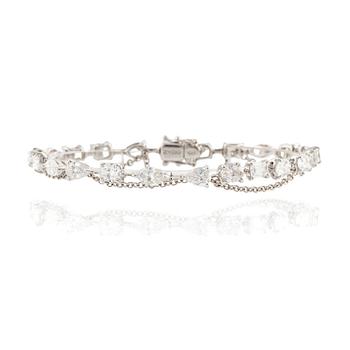 563. An 18K white gold bracelet with brilliant-cut diamonds of various forms, by Zydo.