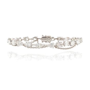 563. An 18K white gold bracelet with brilliant-cut diamonds of various forms, by Zydo.