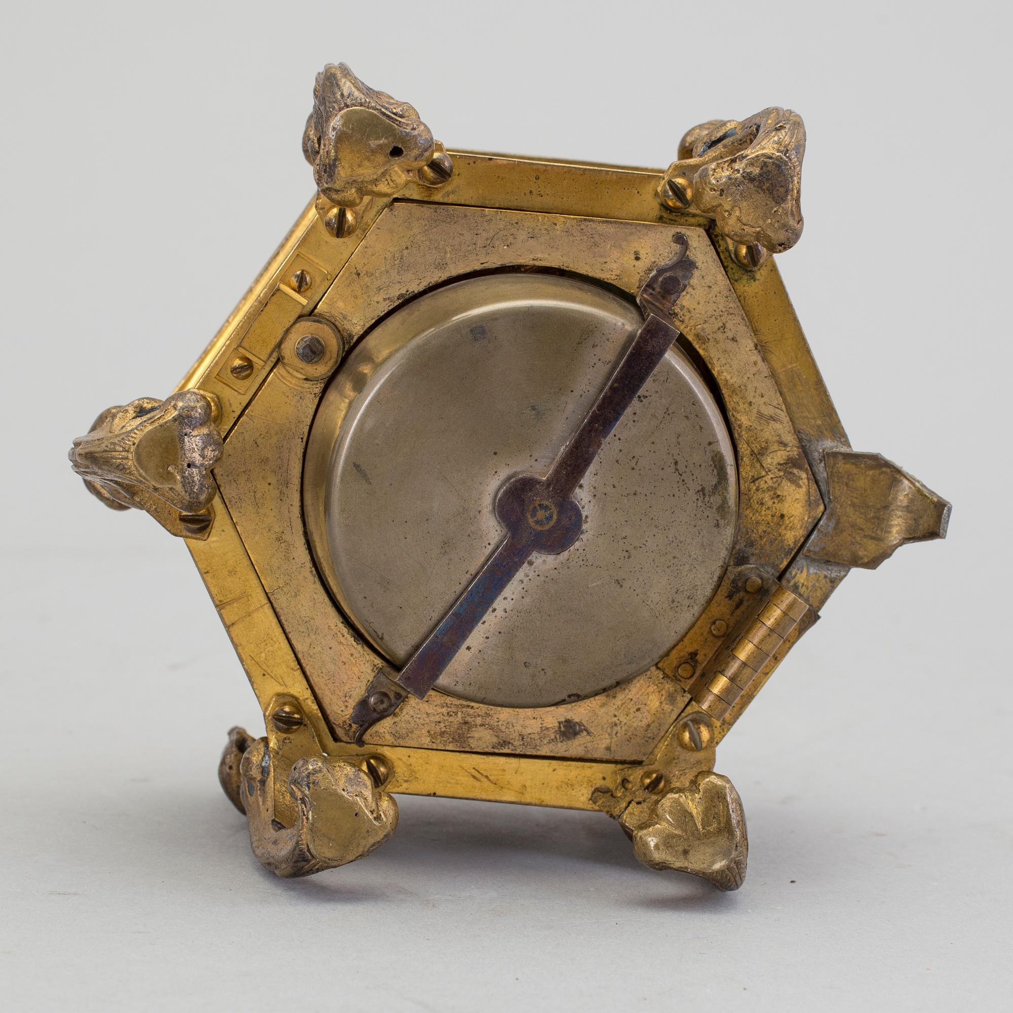 A gilded brass baroque travel clock from around 1700, with original case.
