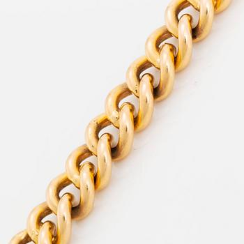 An 18K gold bracelet.