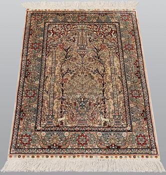 An oriental silk rug, approx. 95 x 63 cm.