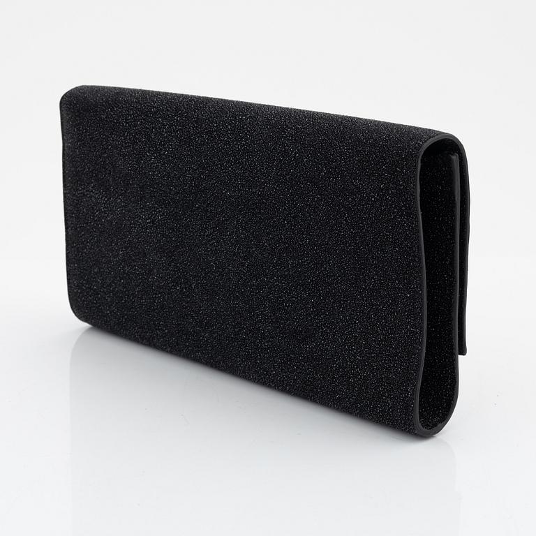 Yves Saint Laurent, a sparkly black leather clutch.