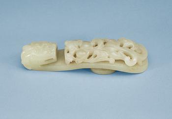 1284. A carved nephrite belt buckle, Qing dynasty.