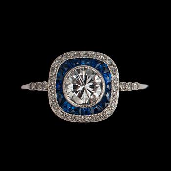 1069. A brilliant cut diamond ring, tot. 0.77 cts set with small blue sapphires.