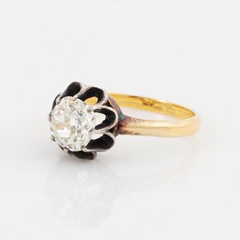 An 18K gold and silver ring set with an old-cut diamond.