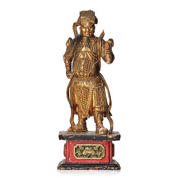 A gilt and lacquered standing figure of a guardsman, Qing dynasty.