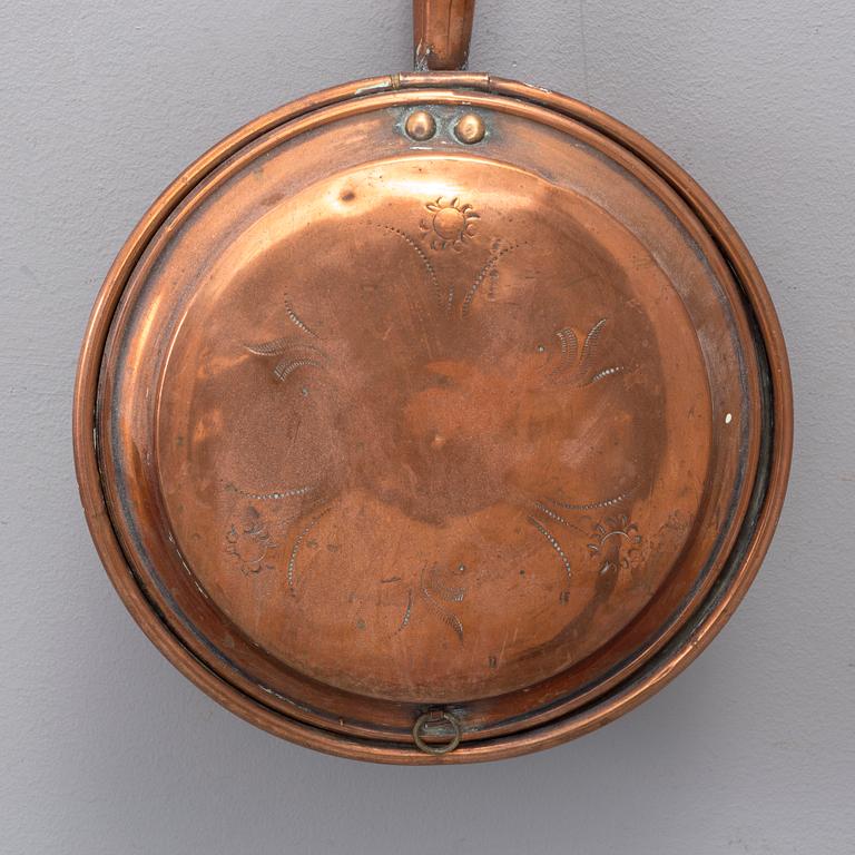 A 18th century copper bed warmer.