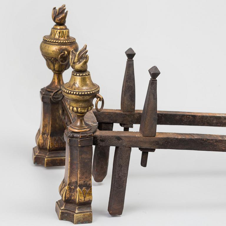 A pair of 19th century Louis XVI style cast iron and brass andirons.