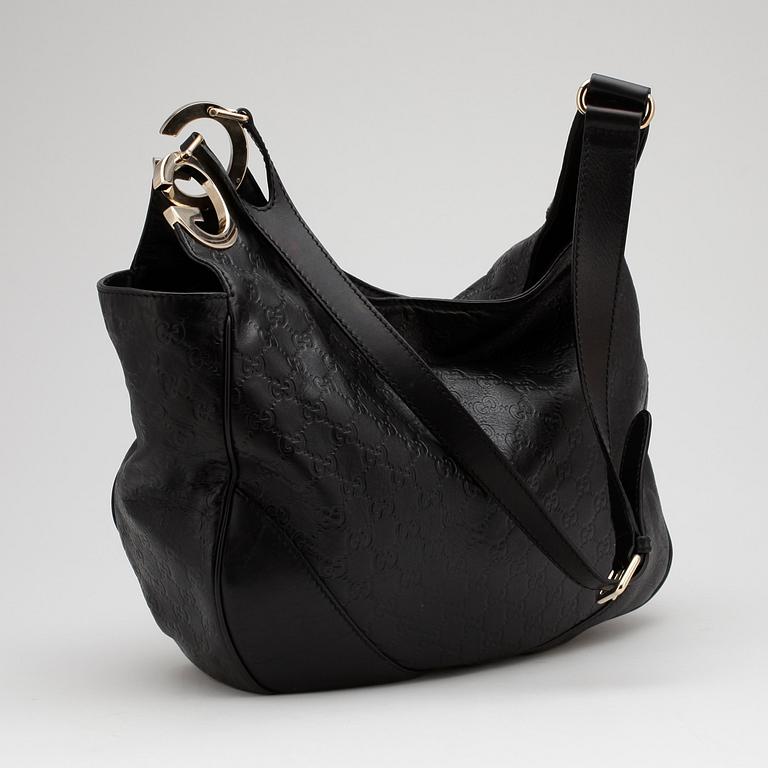 GUCCI, a black monogrammed leather shoulder bag.