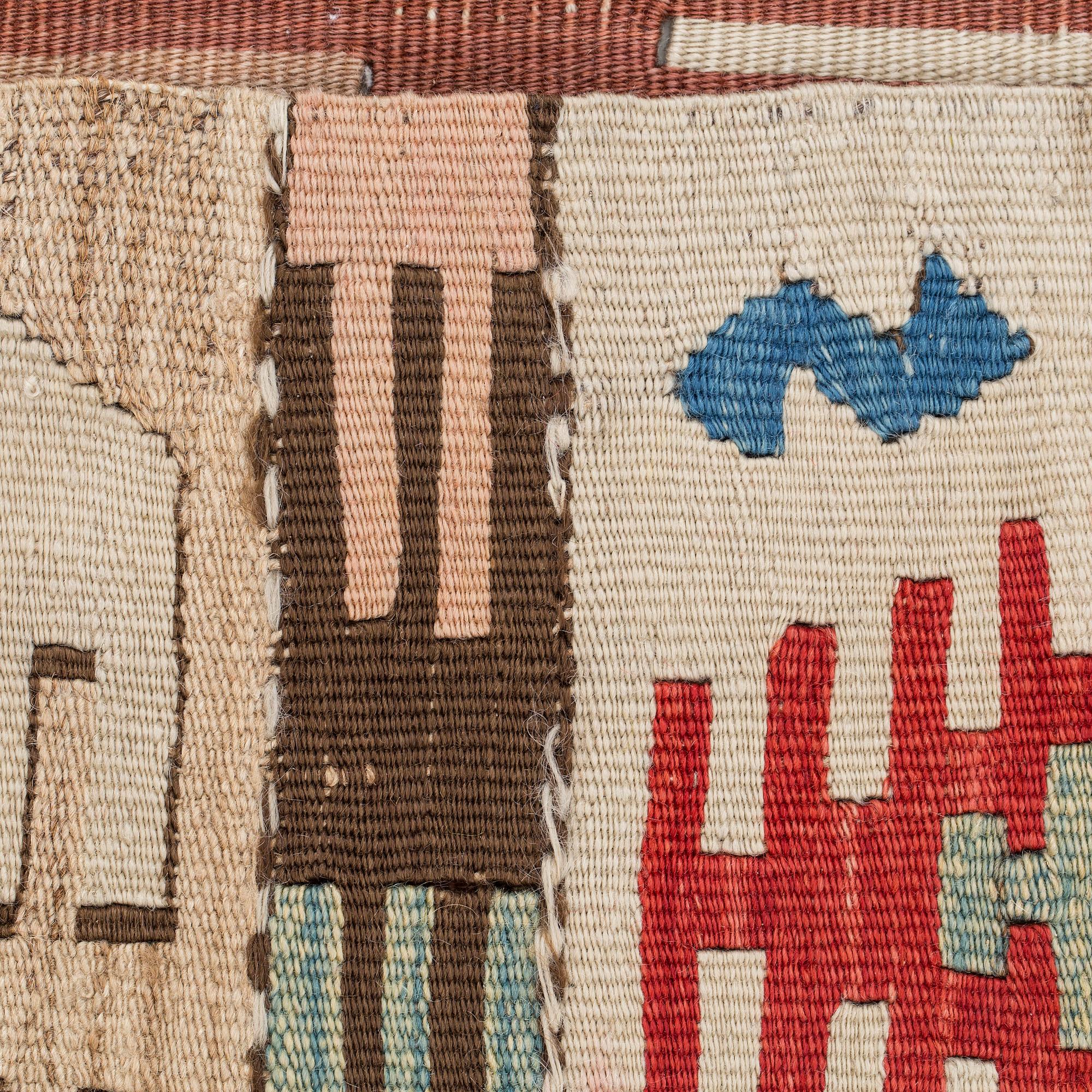 An antique Anatolian kilim fragment in form of a drape, around 232 x 76 cm.
