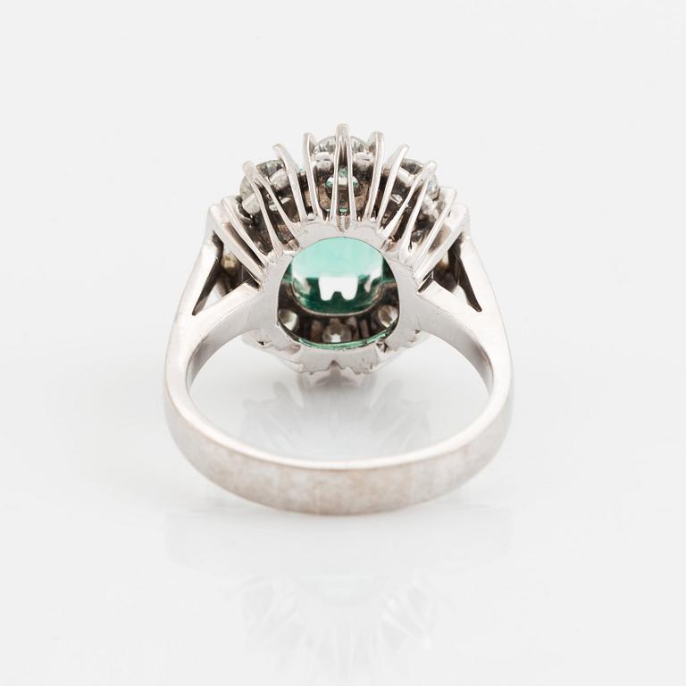 An 18K white gold ring set with a step-cut emerald.