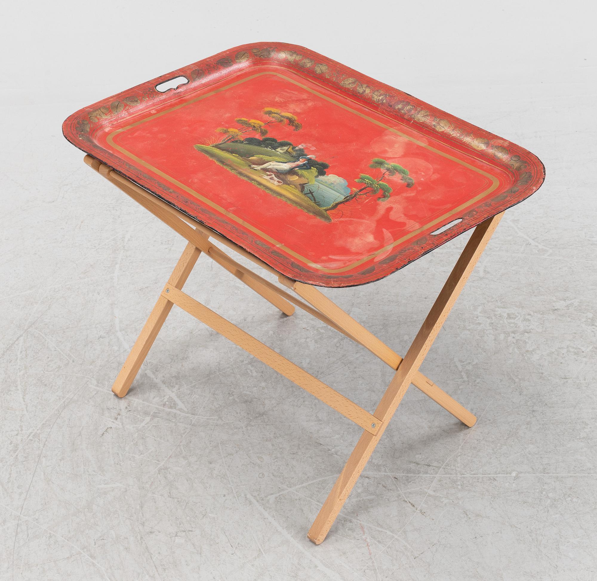 A painted 19th Century tin tray with later stand.