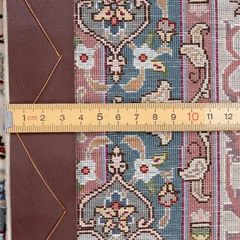 A Tabriz carpet, 210 x 195 cm. signed.