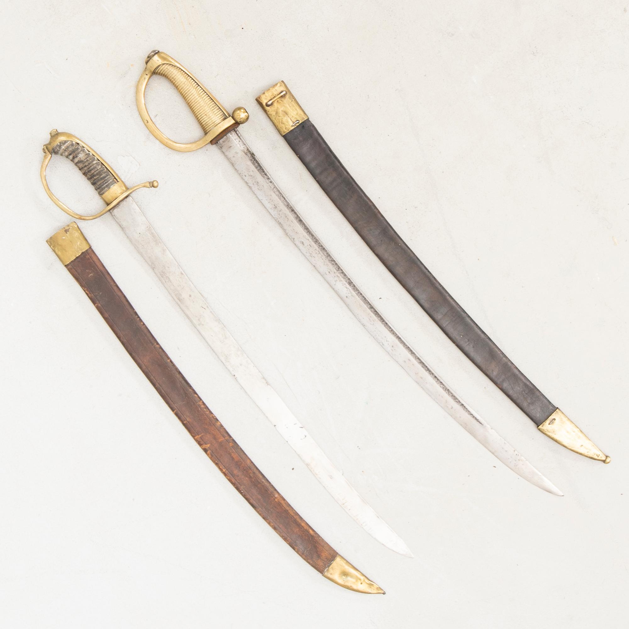 To cutlasses, 19th century, with scabbards.