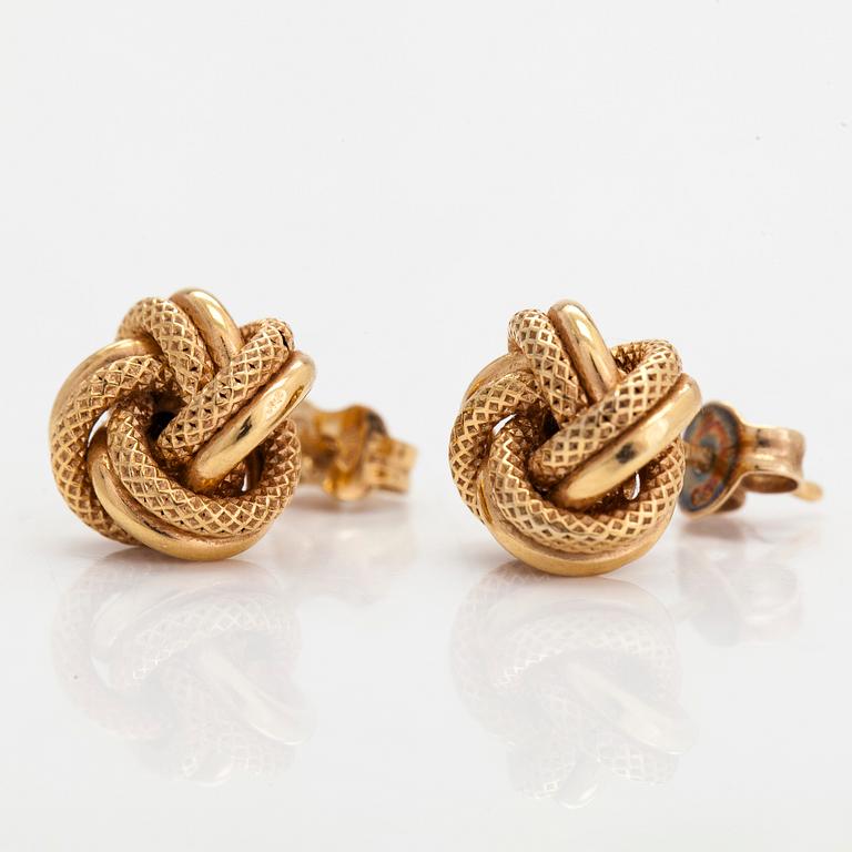 A pair of 14K gold earrings in form of knots.