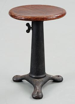 53. An early 20th C cast iron 'Singer' stool with a turnable wooden seat.