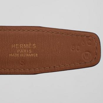 HERMÈS, a black leather belt.