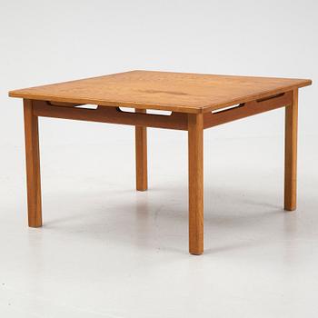 An oak coffee table with a later travertine top.