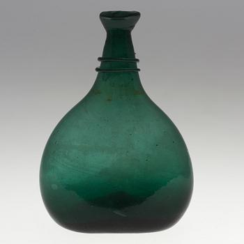 A 18th century glass bottle.