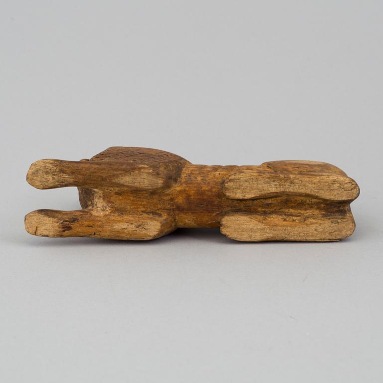 A carved wood sculpture of a lion from the 19th century.