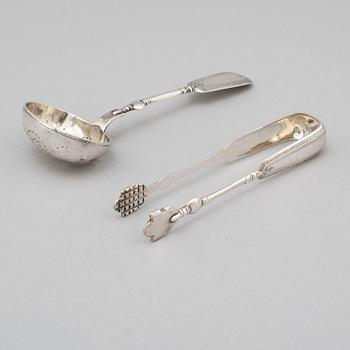 A Russian 19th century silver straining spoon and a pair of sugar tongs, St. Petersburg 1893.