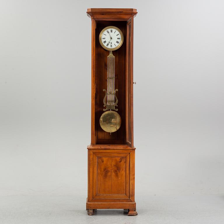 A walnut long case clock, from around the year 1900.