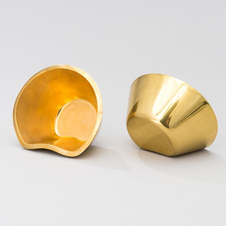A set of four brass ashtrays, designed in 1947.