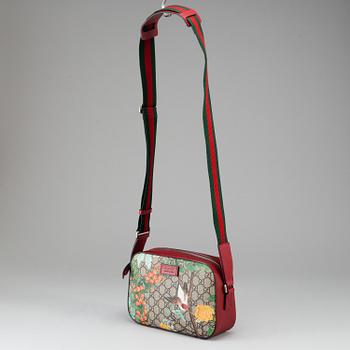 GUCCI, a patterned monogram canvas and leather bag.