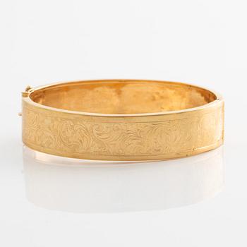 Bangle, 18K gold, with stylized leaf decoration.