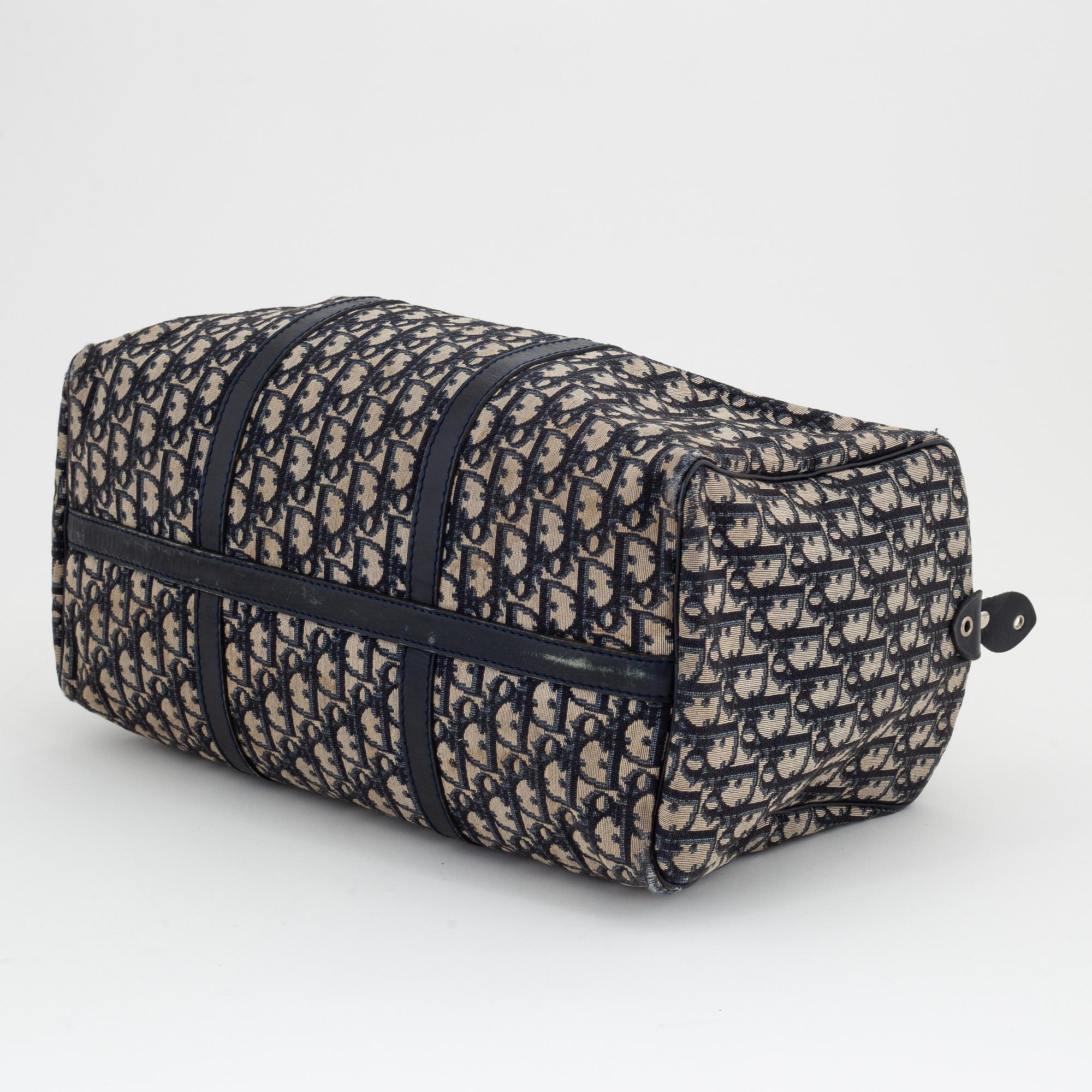 Christian Dior, a canvas handbag, toilet bag and key holder.