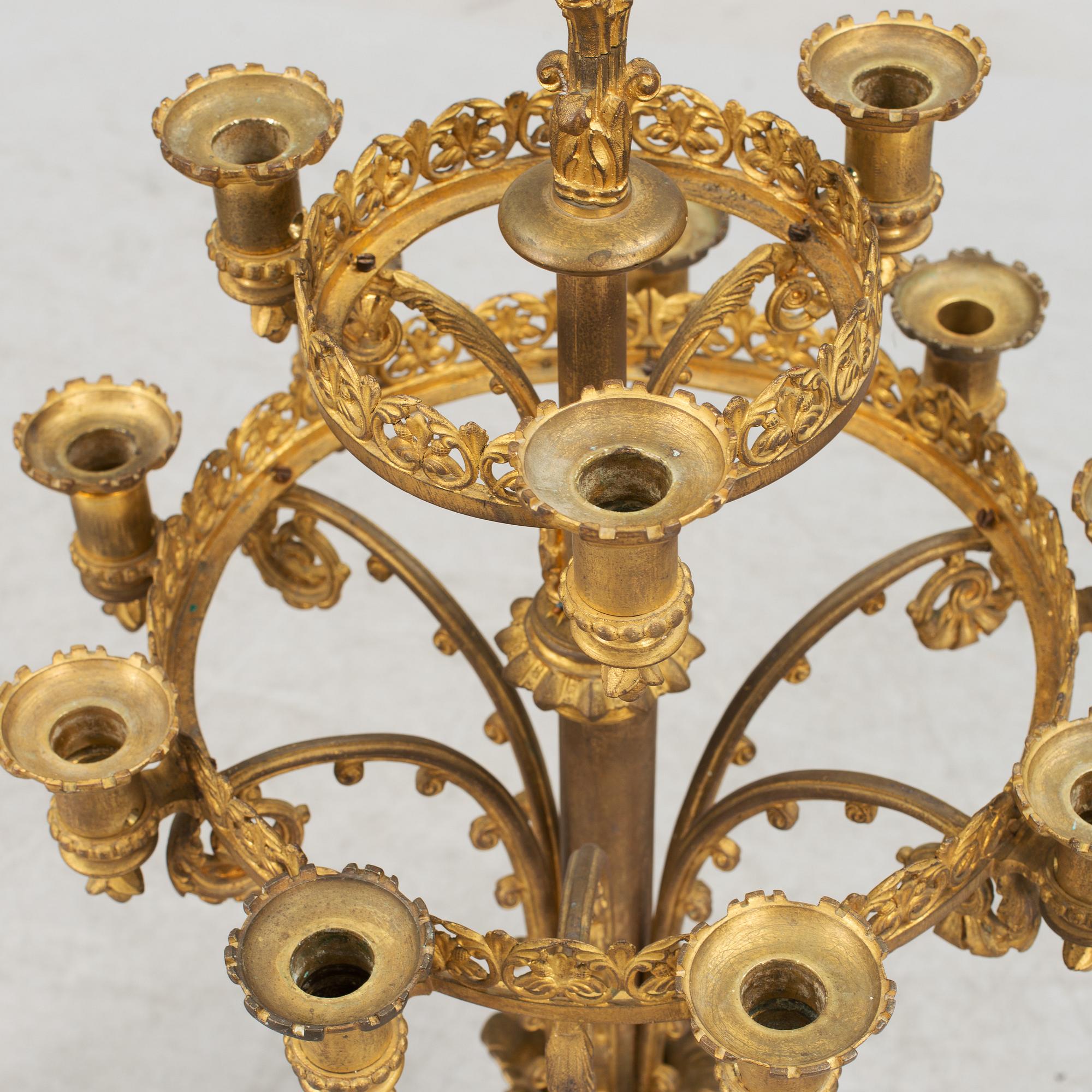 Two similar 19th century bronze candelabras.