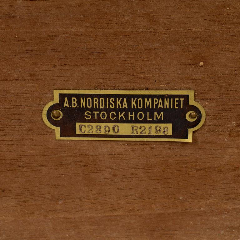 A mid 20th century mahogany veneered table from Nordiska Kompaniet (NK).