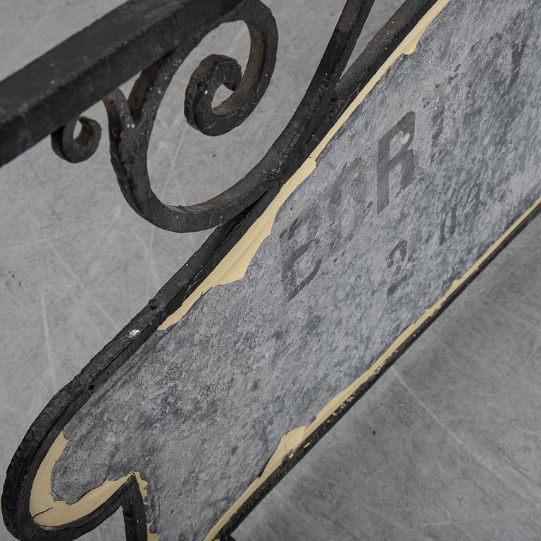 A wrought iron shop sign, 20th Century.