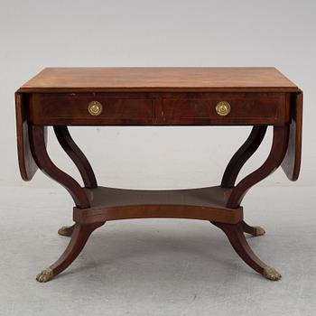 An Empire style mahogany  center table from around the year 1900.