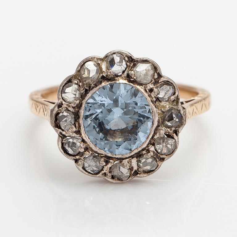 A 13-14K gold ring with a synthetic spinelle and rose-cut dimaonds.