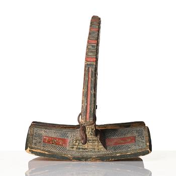 A Swedish folk art carved and polychrome-painted part horse harness, Uppland, dated 1774.