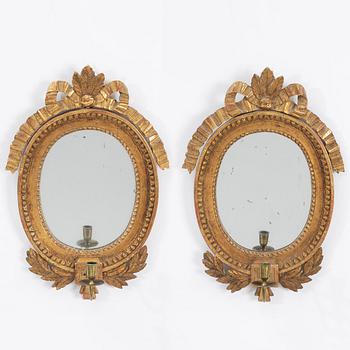 A pair of Gustavian style giltwoos one-branch girandole mirrors, late 19th century.